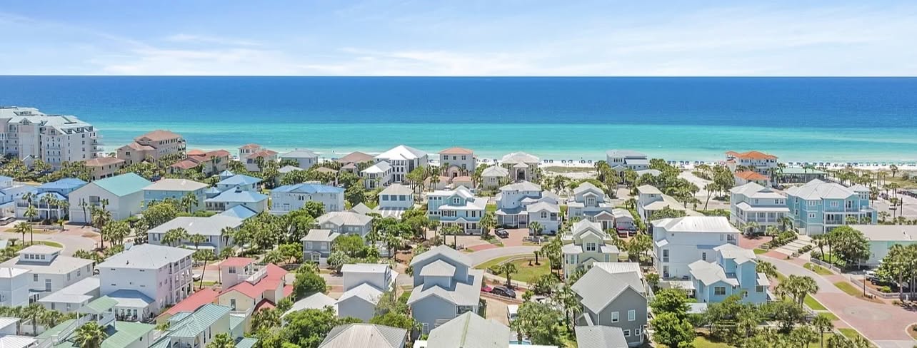 Aerial view of a beachfront neighborhood in Destin, Florida, with the Gulf of Mexico beyond